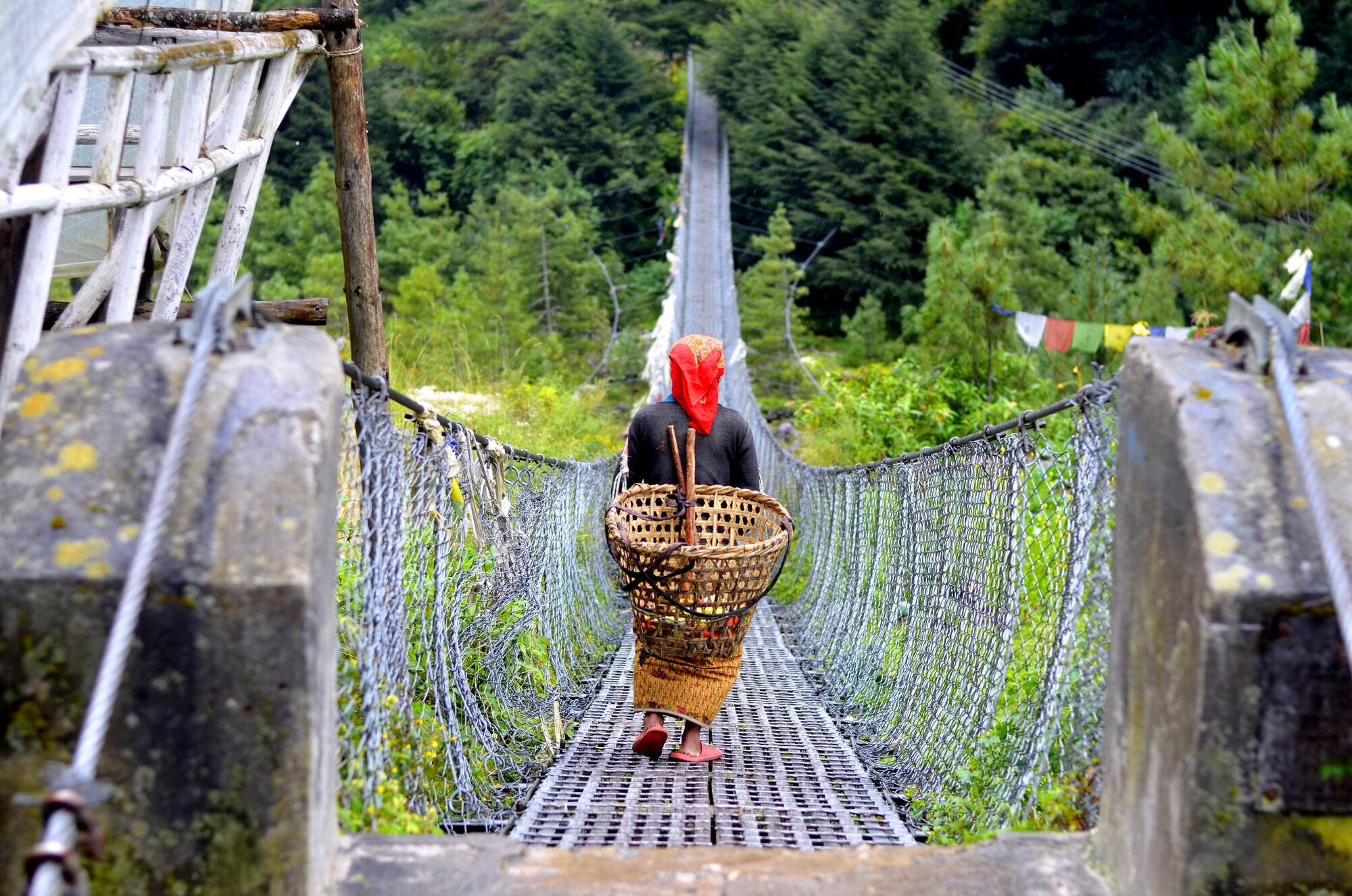 Lady on a suspension bridge, Annapurna, Nepal - By Mountain People